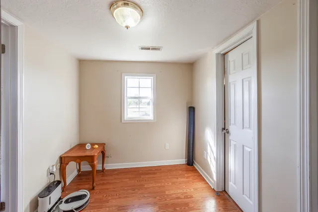 a view of a room with wooden floor and bathroom
