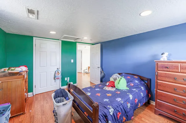 a bathroom with a granite countertop sink a toilet a mirror a vanity and shower