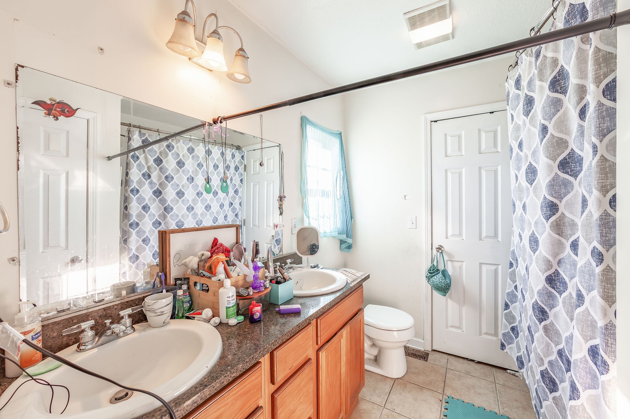 42 Jesse Patterson Road Trenton, TN 38382 - Photo 21 of 27 a bathroom with a granite countertop sink a toilet a mirror a vanity and shower