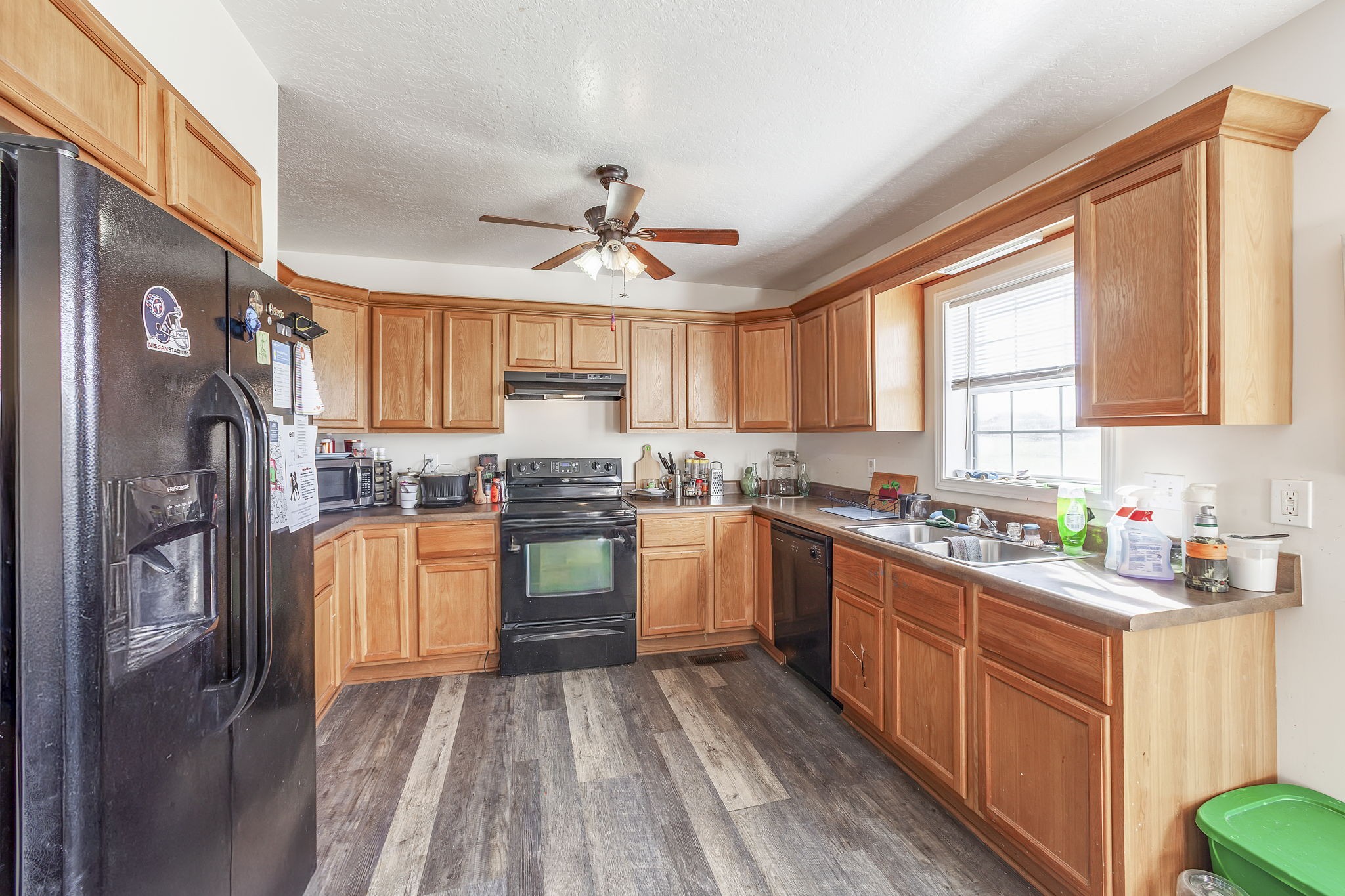 42 Jesse Patterson Road Trenton, TN 38382 - Photo 10 of 27 a kitchen with stainless steel appliances granite countertop a refrigerator a sink dishwasher a stove top oven a refrigerator with white cabinets and wooden floor