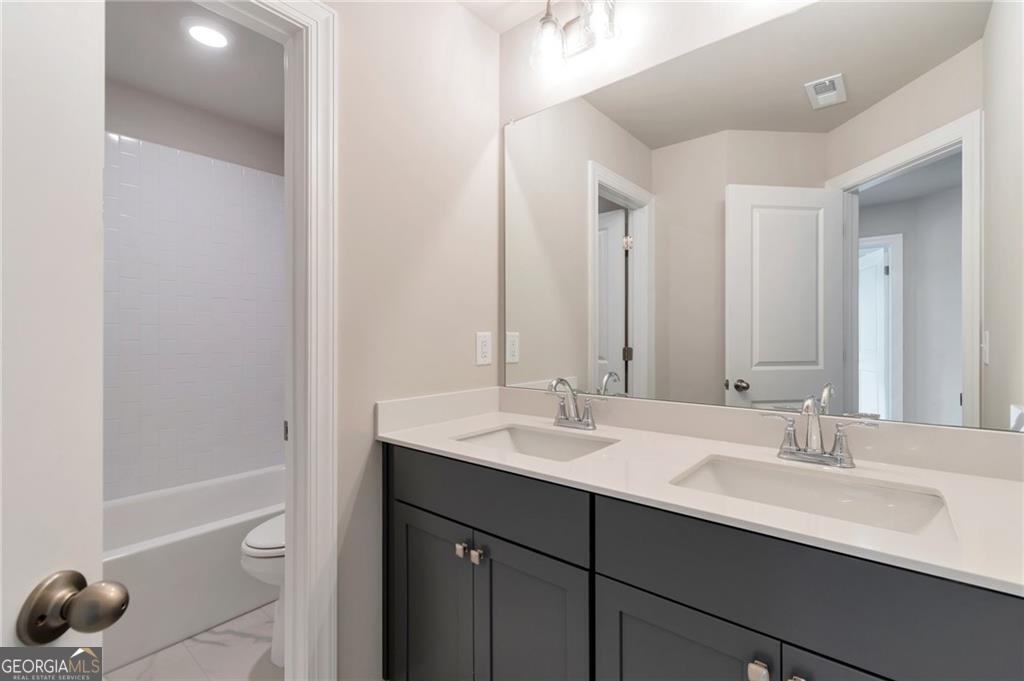 333 Willow Cove Canton, GA 30114 - Photo 18 of 37 a bathroom with a sink a toilet and shower