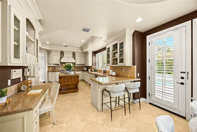 a living room with furniture a rug and kitchen view