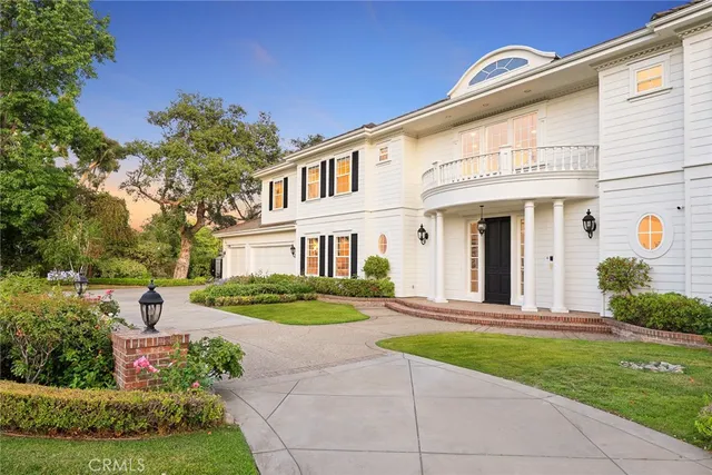 a front view of a house with a yard and outdoor seating