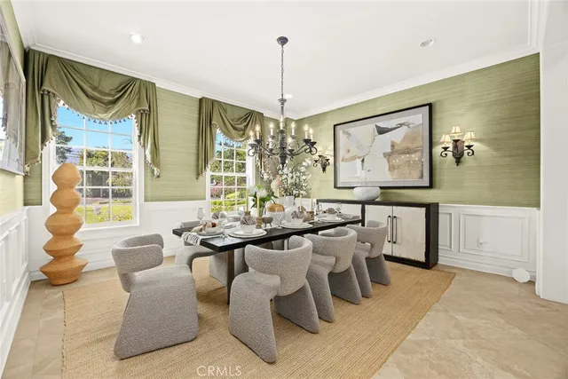 a living room with fireplace furniture and a chandelier