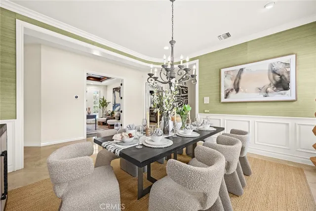 a view of a dining room with furniture wooden floor and chandelier