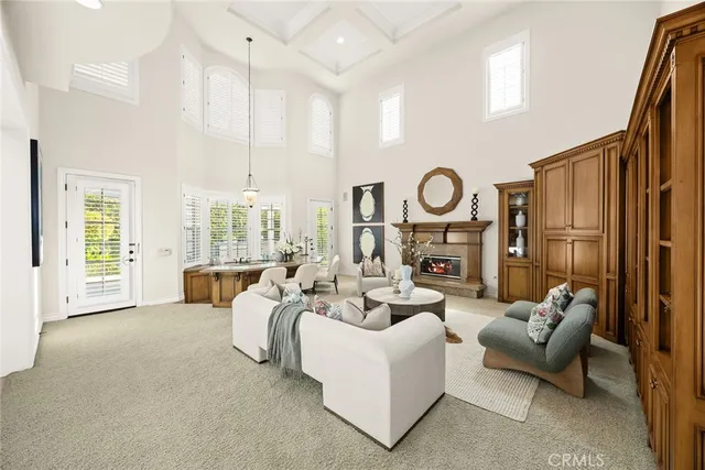 a living room with furniture wooden floor and a large window