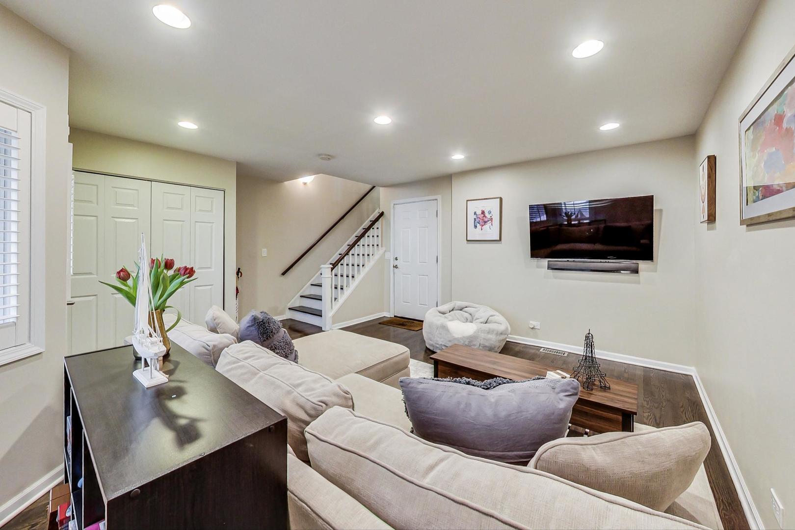 1351 West Altgeld Street, Unit 4D Chicago, IL 60614 - Photo 3 of 30 a living room with furniture and a flat screen tv