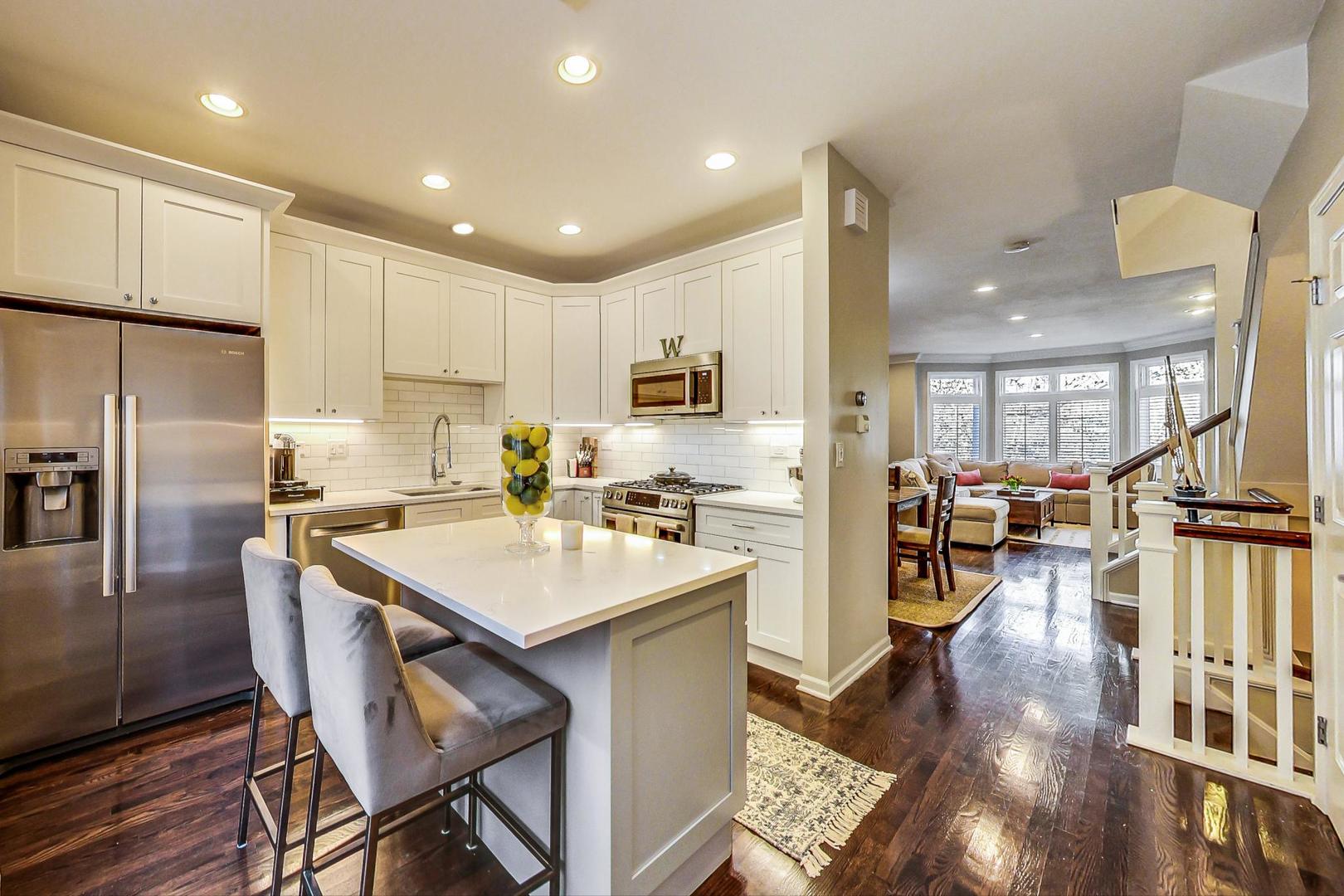 1351 West Altgeld Street, Unit 4D Chicago, IL 60614 - Photo 10 of 30 a kitchen with counter space dining table and stainless steel appliances