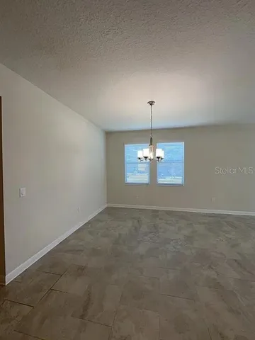 a view of a chandelier fan and entryway
