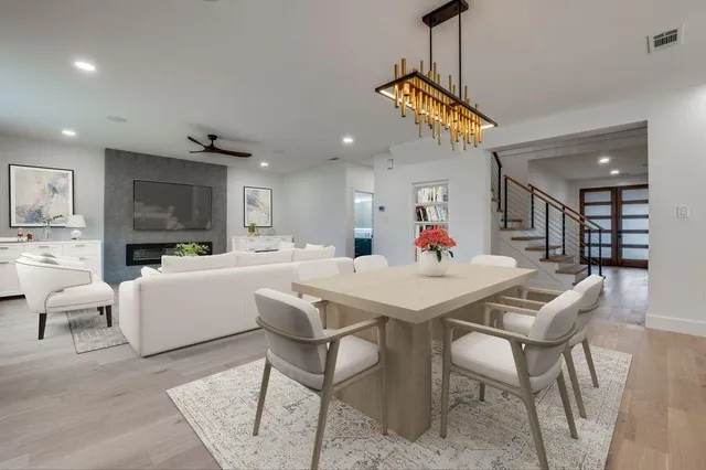 a dining room with furniture and a chandelier