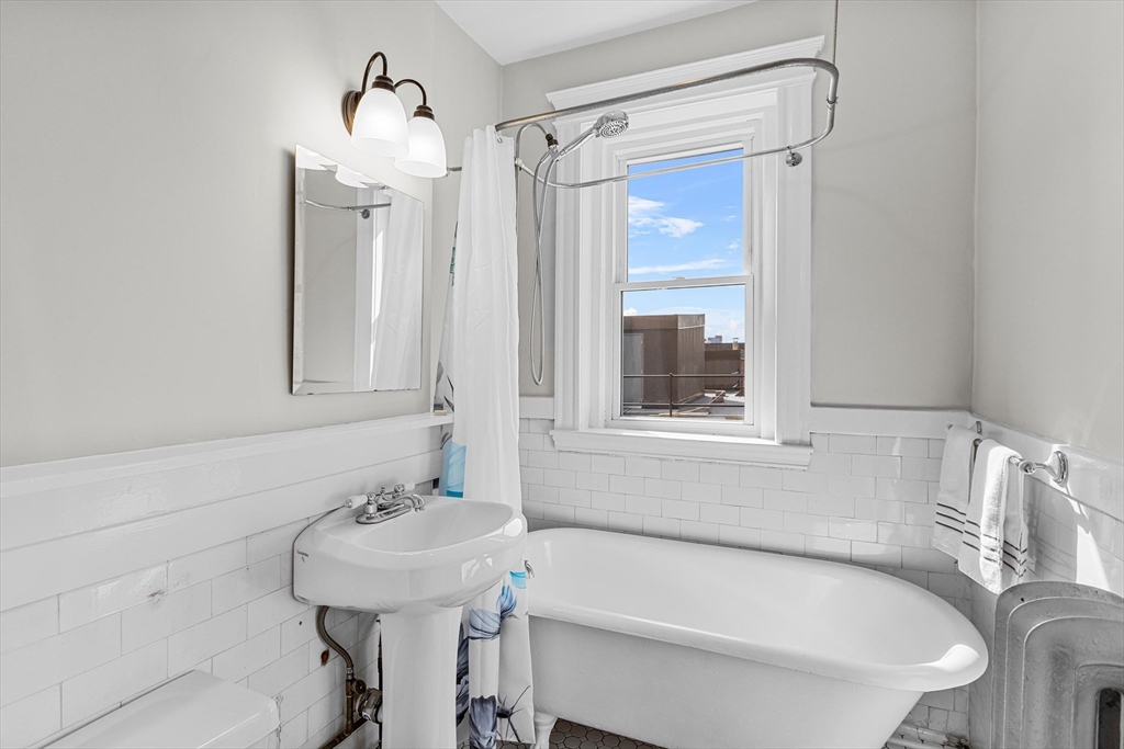 15 Park Drive, Unit 35 Boston, MA 02215 - Photo 5 of 9 a bathroom with a tub sink and mirror