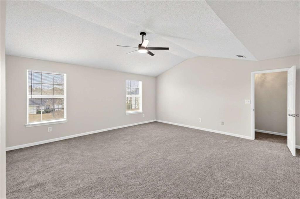 1727 Rice Square Lithonia, GA 30058 - Photo 17 of 33 an empty room with windows and fan