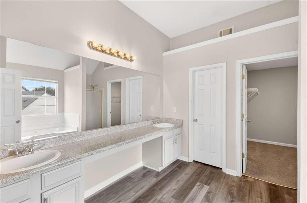 1727 Rice Square Lithonia, GA 30058 - Photo 20 of 33 a spacious bathroom with a granite countertop sink and a mirror