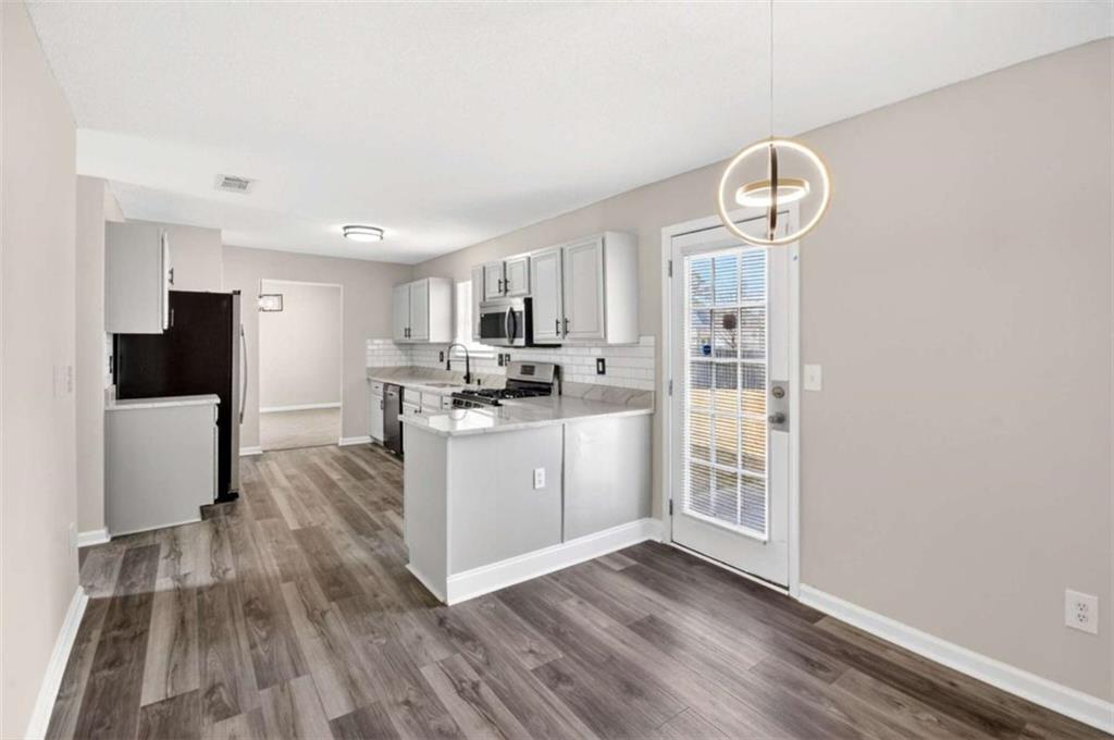 1727 Rice Square Lithonia, GA 30058 - Photo 7 of 33 a kitchen with cabinets and wooden floor