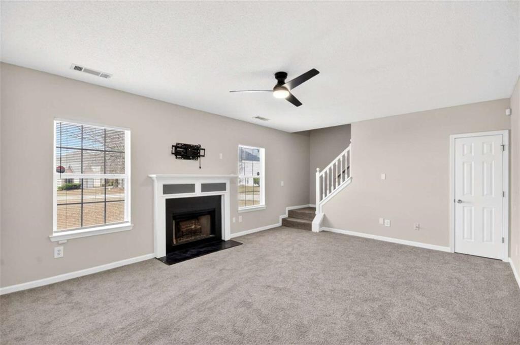 1727 Rice Square Lithonia, GA 30058 - Photo 9 of 33 a view of an empty room with a fireplace and a window