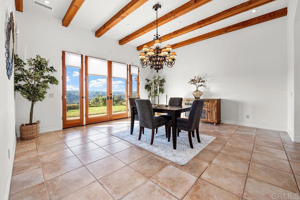 2155 Mil Sorpresas Drive Fallbrook, CA 92028 - Photo 11 of 48 a view of a dining room with furniture and chandelier