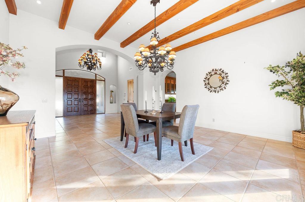2155 Mil Sorpresas Drive Fallbrook, CA 92028 - Photo 12 of 48 a view of a dining room with furniture and a chandelier