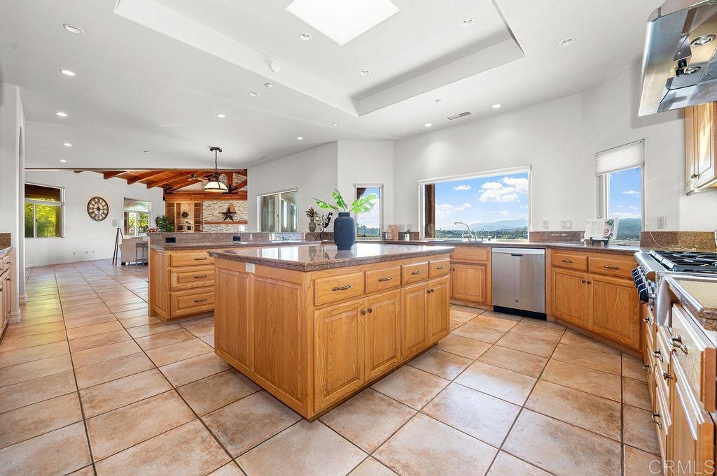 2155 Mil Sorpresas Drive Fallbrook, CA 92028 - Photo 17 of 48 a kitchen with stainless steel appliances granite countertop a sink counter space cabinets and a view of kitchen