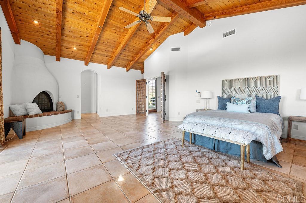 2155 Mil Sorpresas Drive Fallbrook, CA 92028 - Photo 22 of 48 a spacious bedroom with a bed and a walk in closet