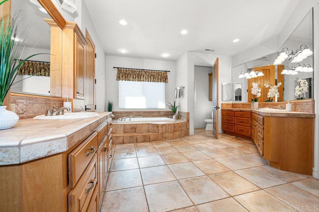 2155 Mil Sorpresas Drive Fallbrook, CA 92028 - Photo 25 of 48 a large bathroom with a large tub and sink