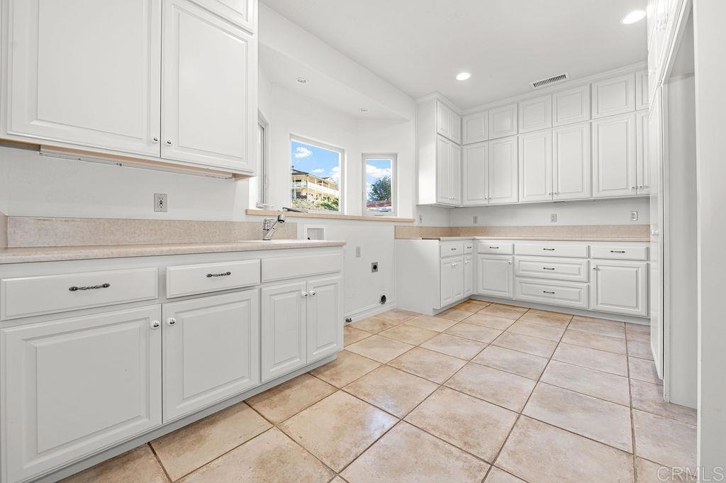 2155 Mil Sorpresas Drive Fallbrook, CA 92028 - Photo 33 of 48 a kitchen with white cabinets granite counter tops and white appliances