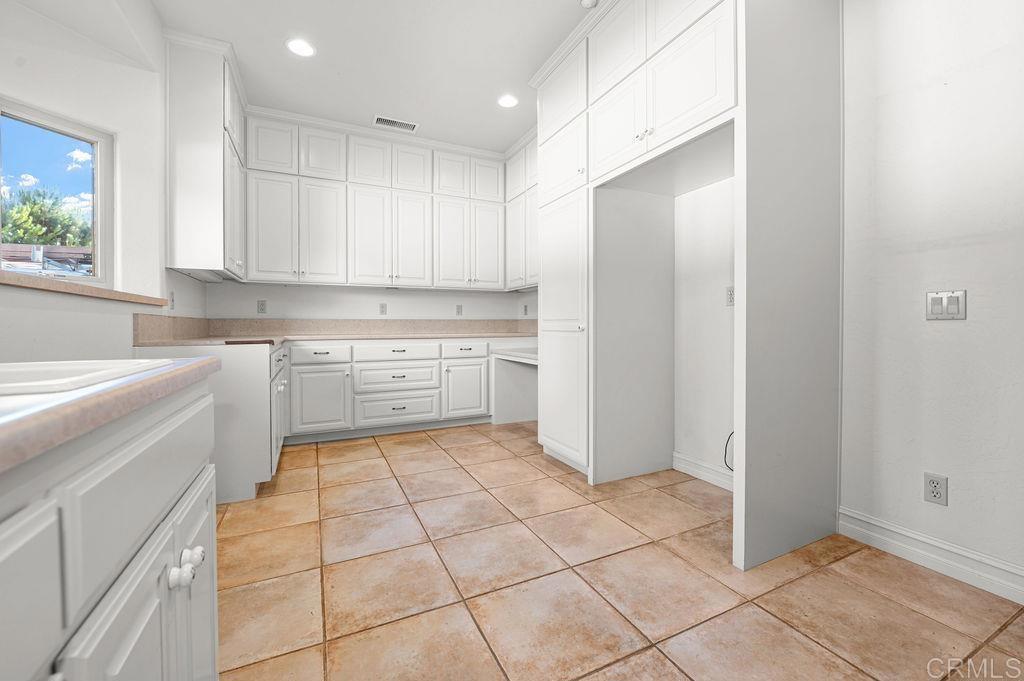 2155 Mil Sorpresas Drive Fallbrook, CA 92028 - Photo 34 of 48 a kitchen with a cabinets and a refrigerator