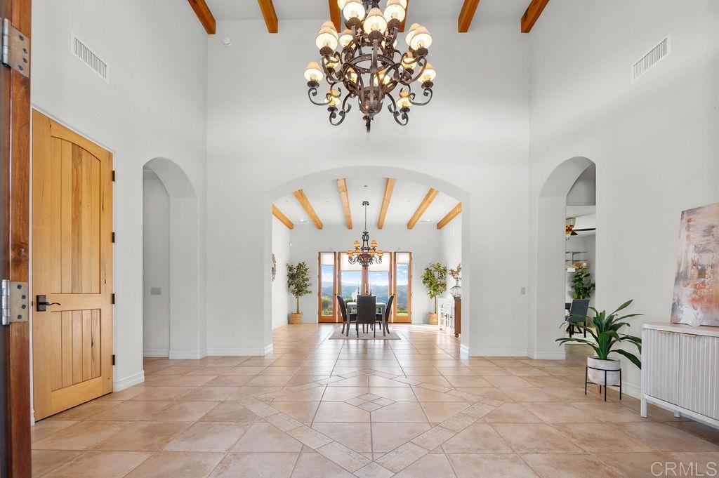 2155 Mil Sorpresas Drive Fallbrook, CA 92028 - Photo 7 of 48 a view of a livingroom with a potted plant a dinning room and chandelier