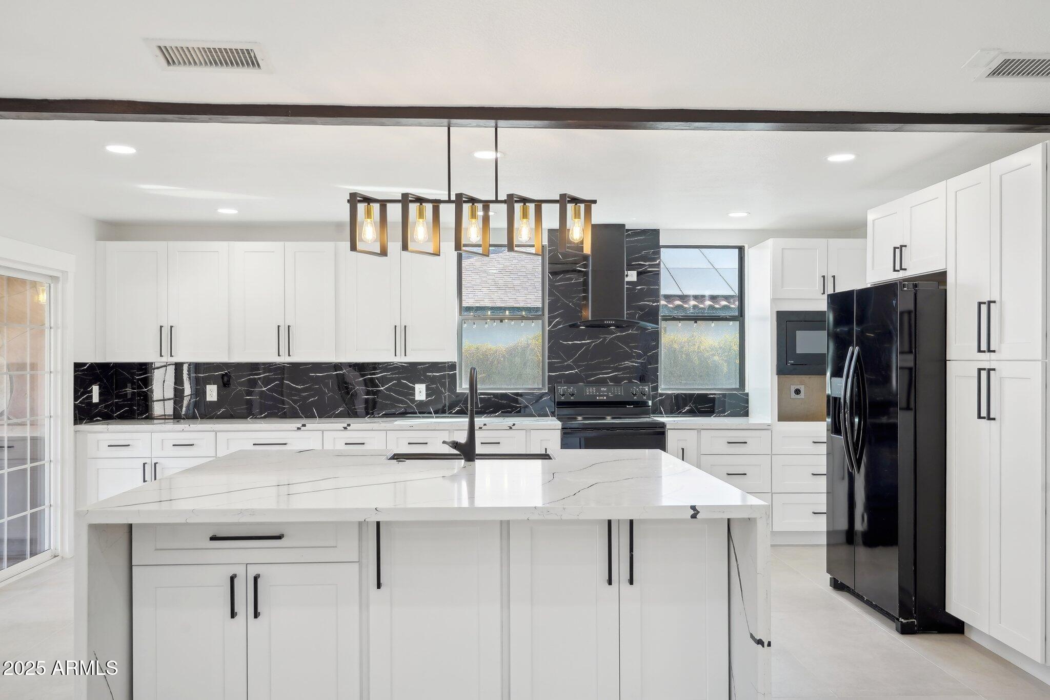 5704 East Estrid Avenue Scottsdale, AZ 85254 - Photo 12 of 48 a kitchen with stainless steel appliances a sink and a refrigerator