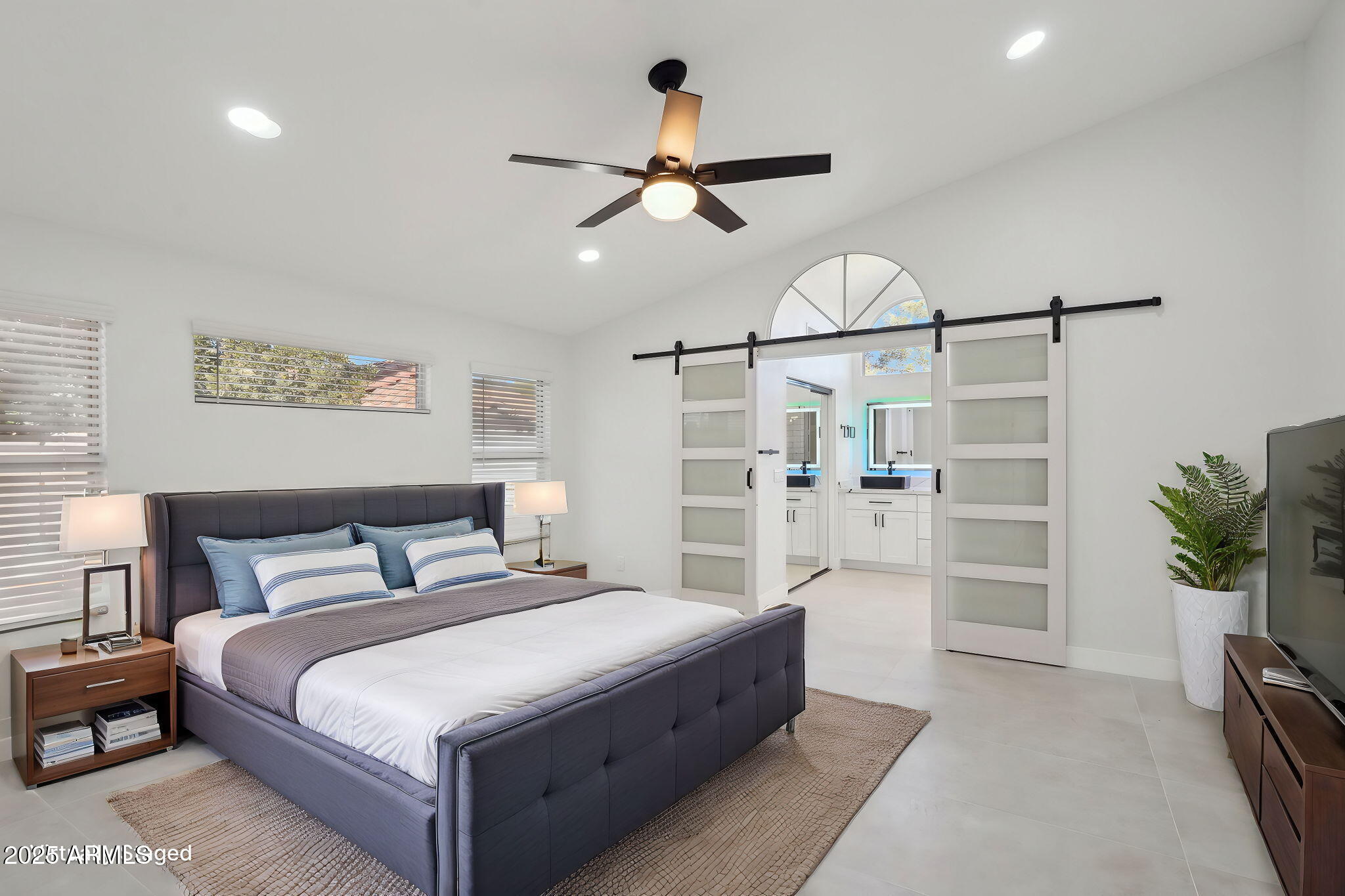 5704 East Estrid Avenue Scottsdale, AZ 85254 - Photo 13 of 48 a bedroom with a large bed and a chandelier