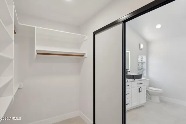 a bathroom with a toilet sink and a mirror