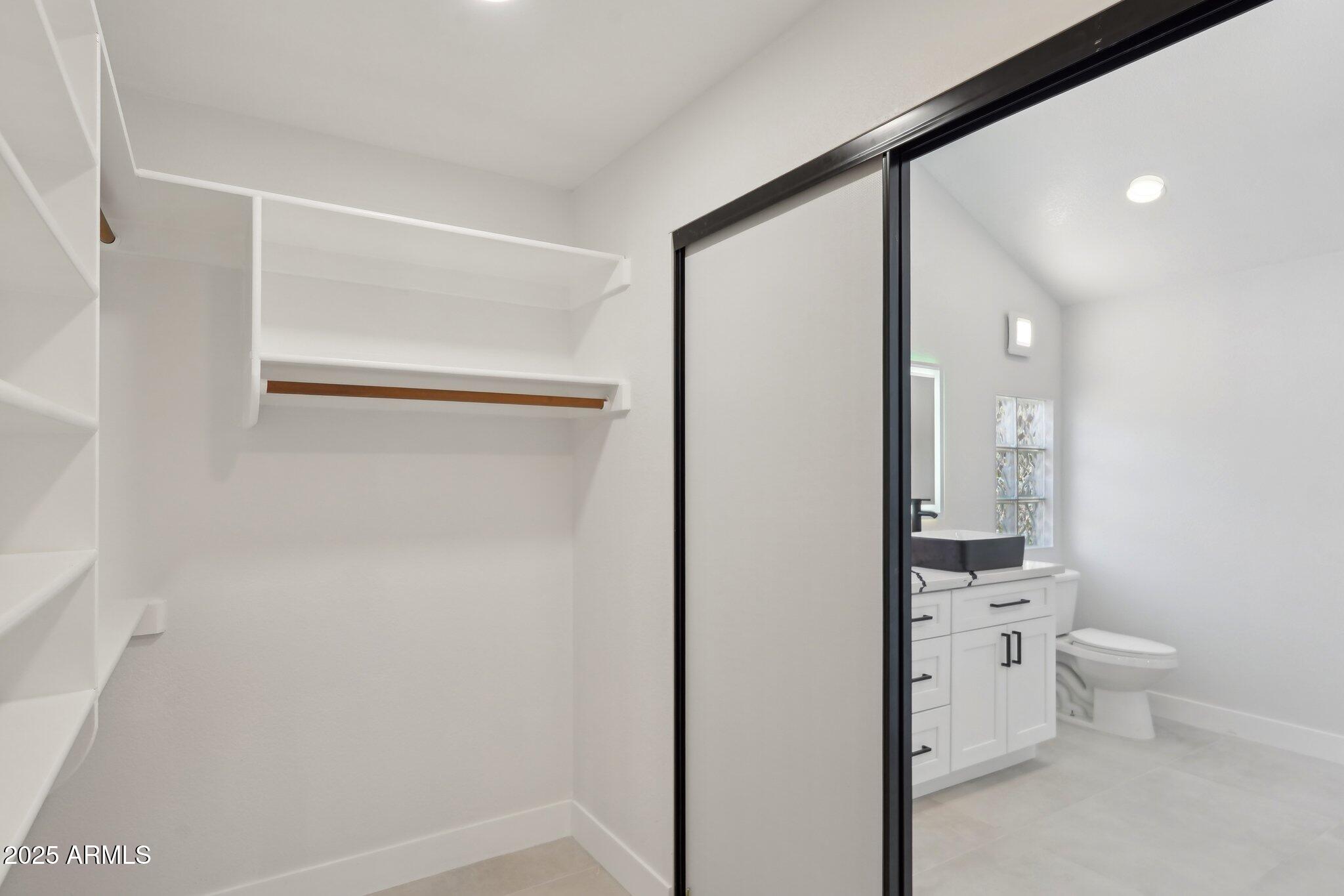 5704 East Estrid Avenue Scottsdale, AZ 85254 - Photo 20 of 48 a bathroom with a toilet sink and a mirror