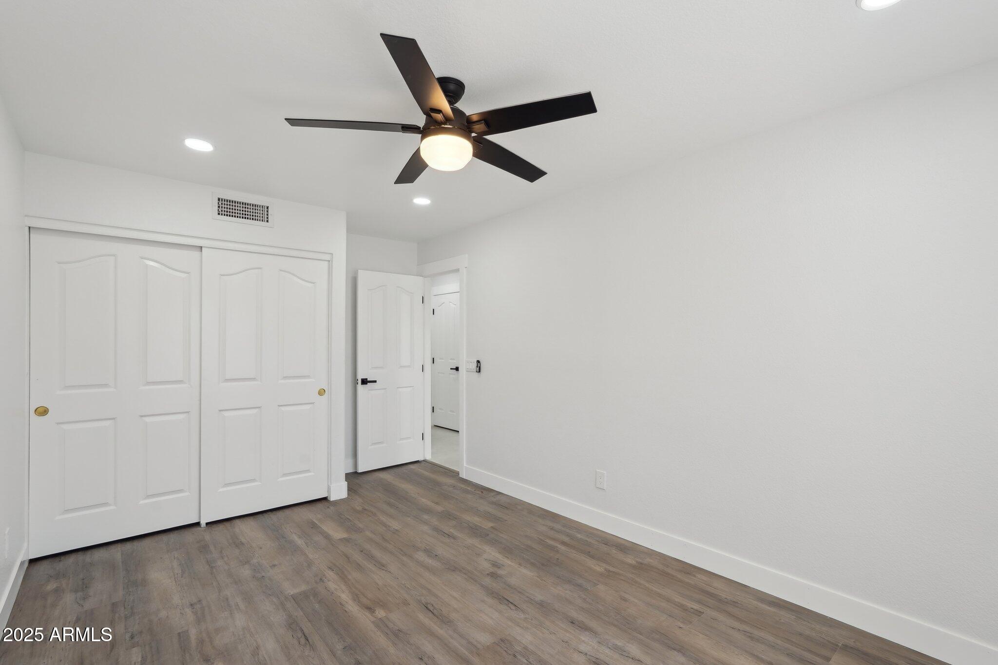5704 East Estrid Avenue Scottsdale, AZ 85254 - Photo 22 of 48 a view of a room with wooden floor and ceiling fan