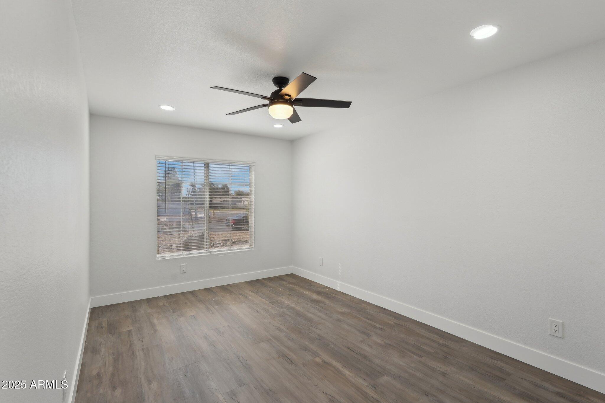 5704 East Estrid Avenue Scottsdale, AZ 85254 - Photo 23 of 48 wooden floor in an empty room with a window