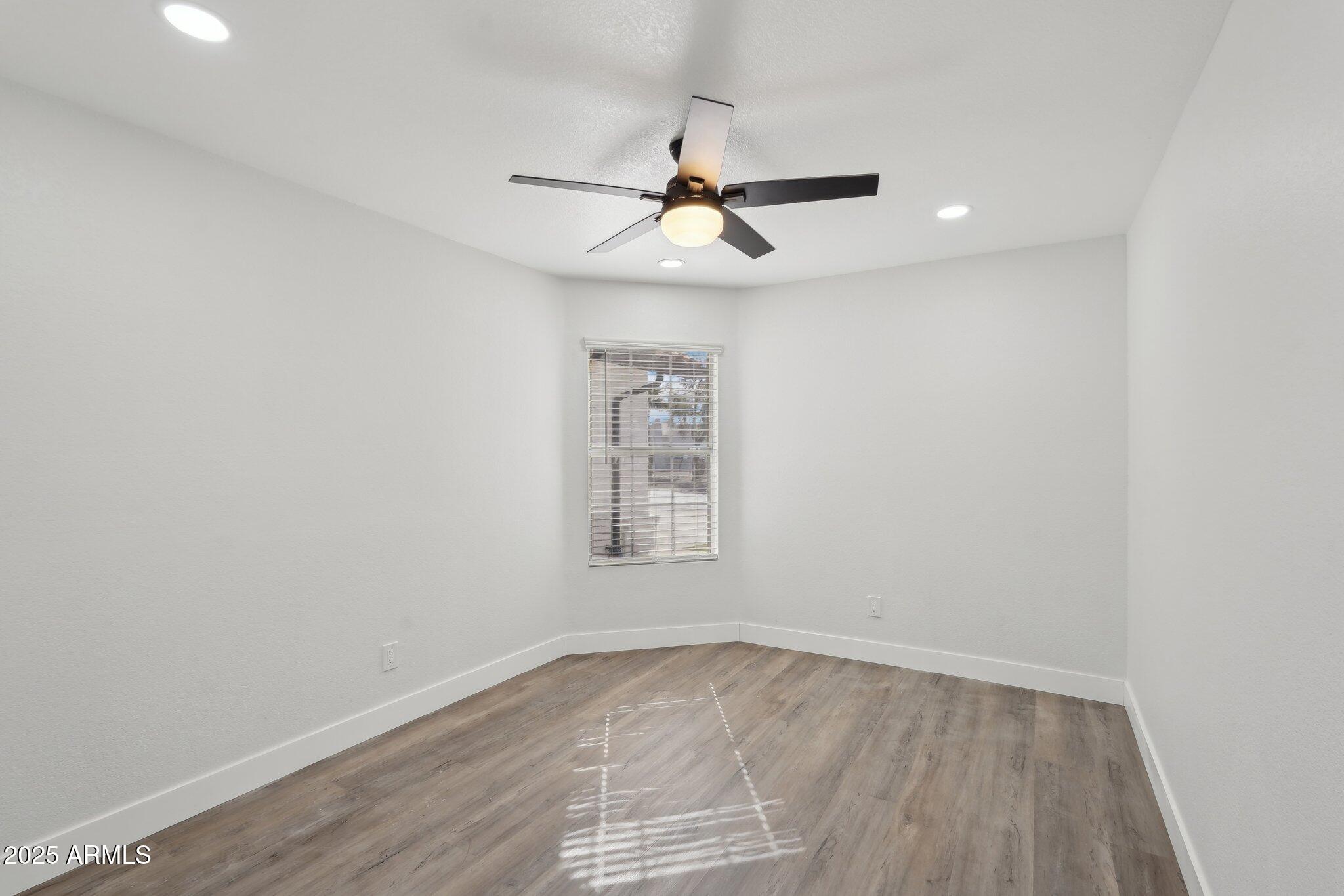 5704 East Estrid Avenue Scottsdale, AZ 85254 - Photo 25 of 48 an empty room with a window and ceiling fan