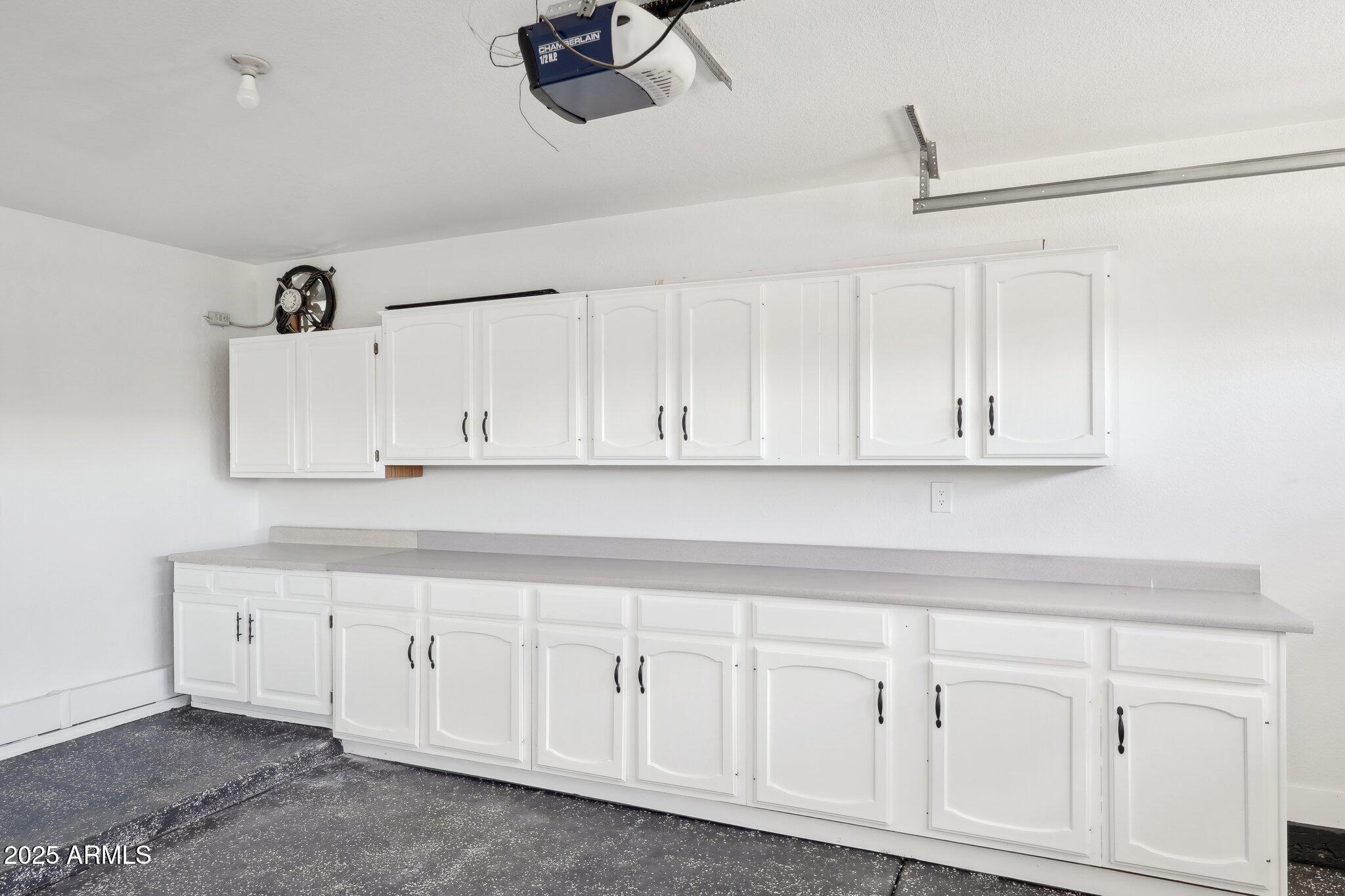 5704 East Estrid Avenue Scottsdale, AZ 85254 - Photo 34 of 48 a kitchen with white cabinets and white appliances