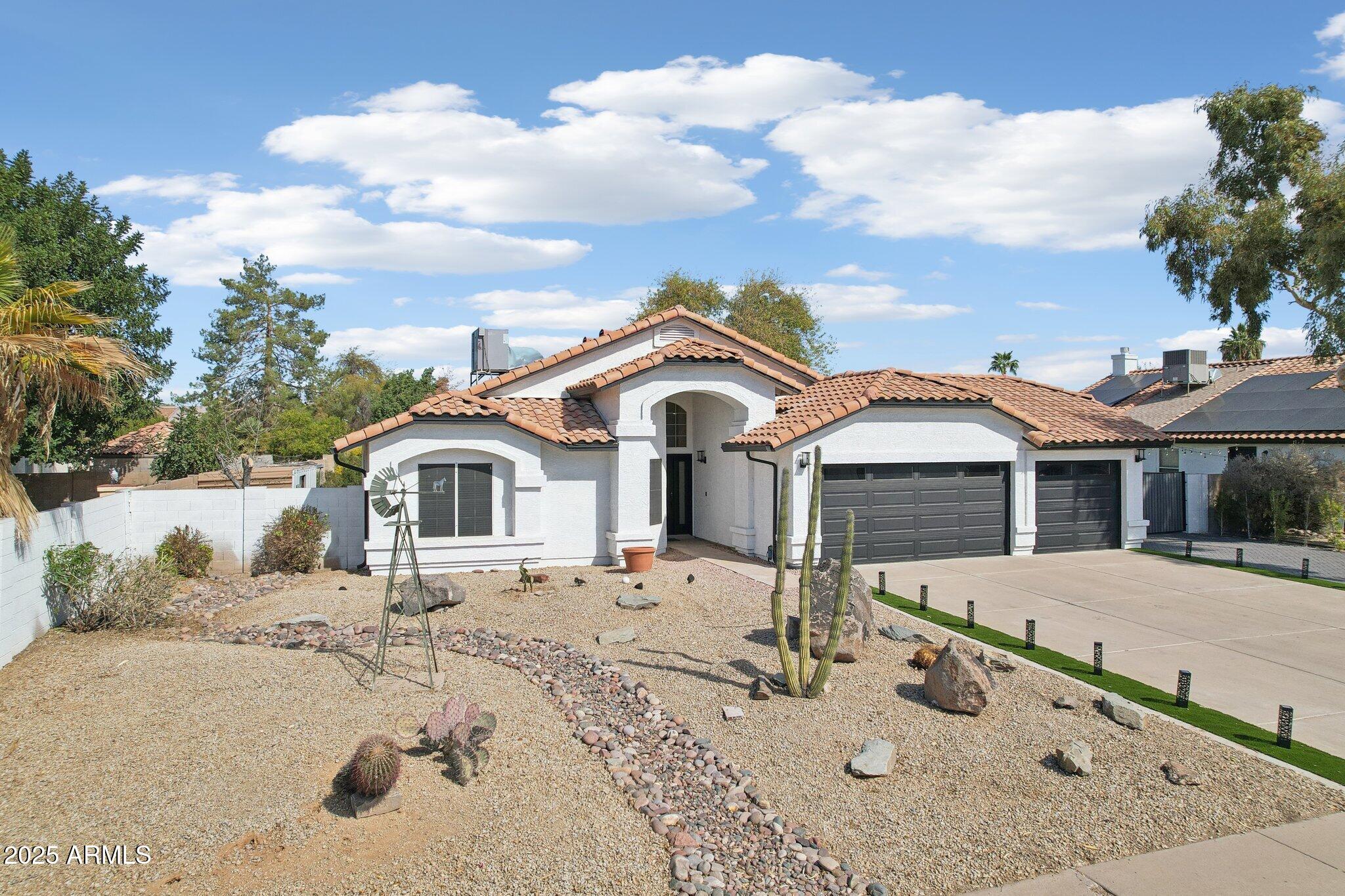 5704 East Estrid Avenue Scottsdale, AZ 85254 - Photo 37 of 48 a front view of a house with a yard covered in snow