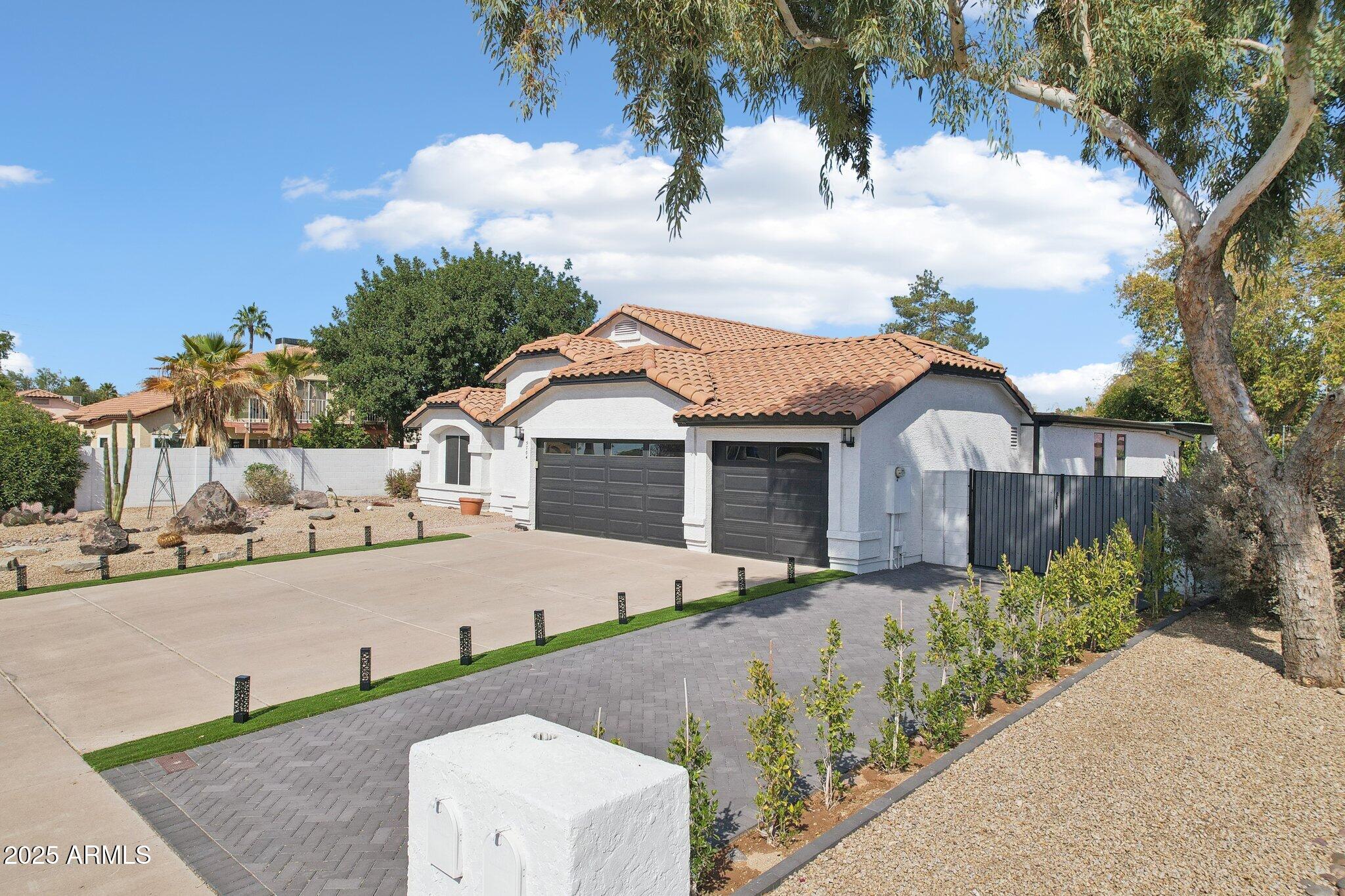 5704 East Estrid Avenue Scottsdale, AZ 85254 - Photo 38 of 48 a front view of a house with a yard and garage