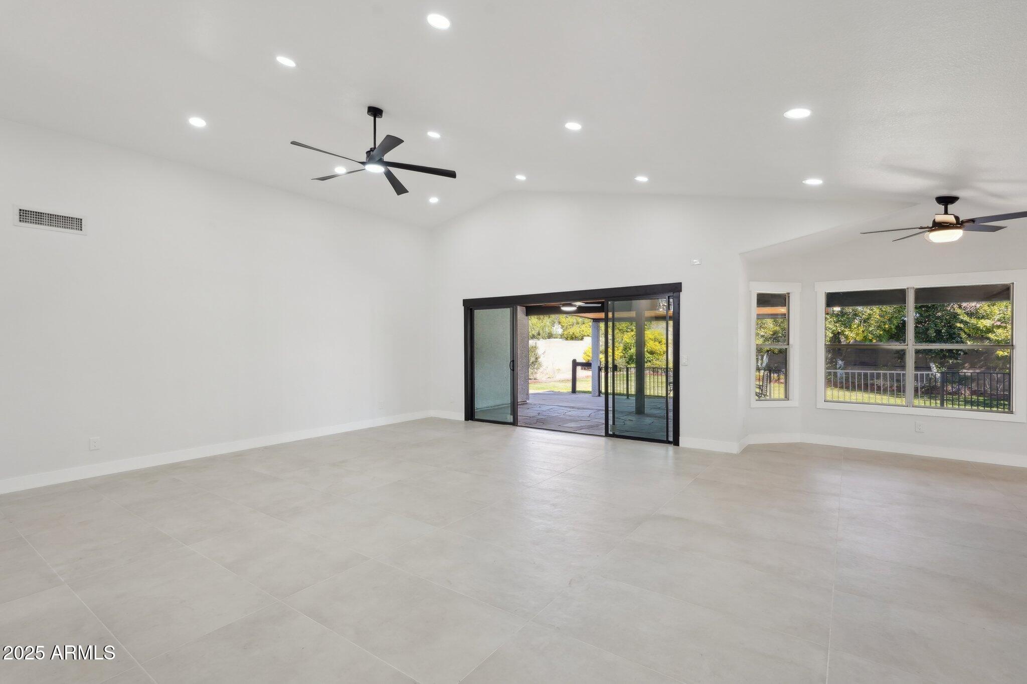 5704 East Estrid Avenue Scottsdale, AZ 85254 - Photo 8 of 48 an empty room with windows and ceiling fan