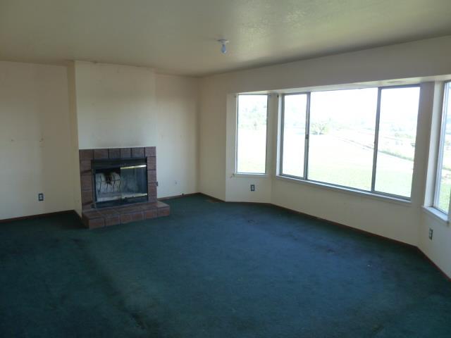 77 Overpass Road, Unit B Watsonville, CA 95076 - Photo 4 of 10 a view of an empty room with a window and fire place