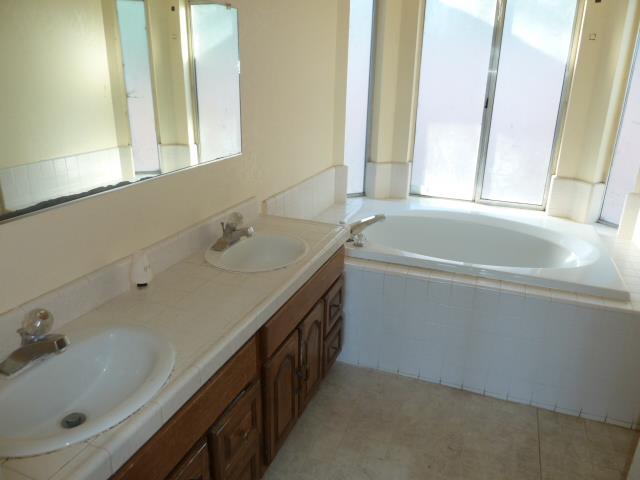 77 Overpass Road, Unit B Watsonville, CA 95076 - Photo 9 of 10 a bathroom with a tub sink and mirror