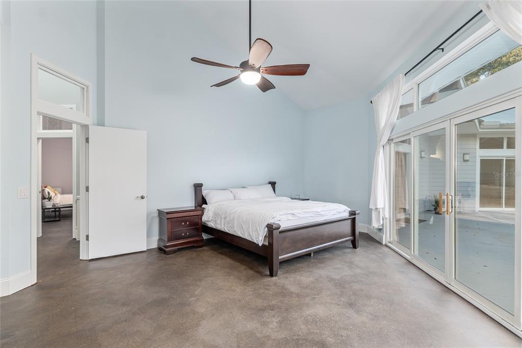 6012 168th Street Alachua, FL 32615 - Photo 25 of 48 a bed room with a bed and a chandelier