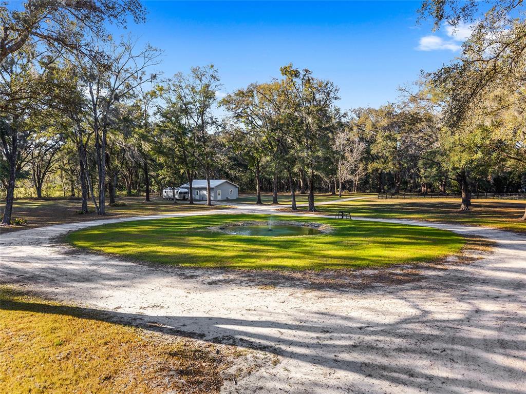 6012 168th Street Alachua, FL 32615 - Photo 5 of 48 a view of swimming pool with outdoor space and trees in the background