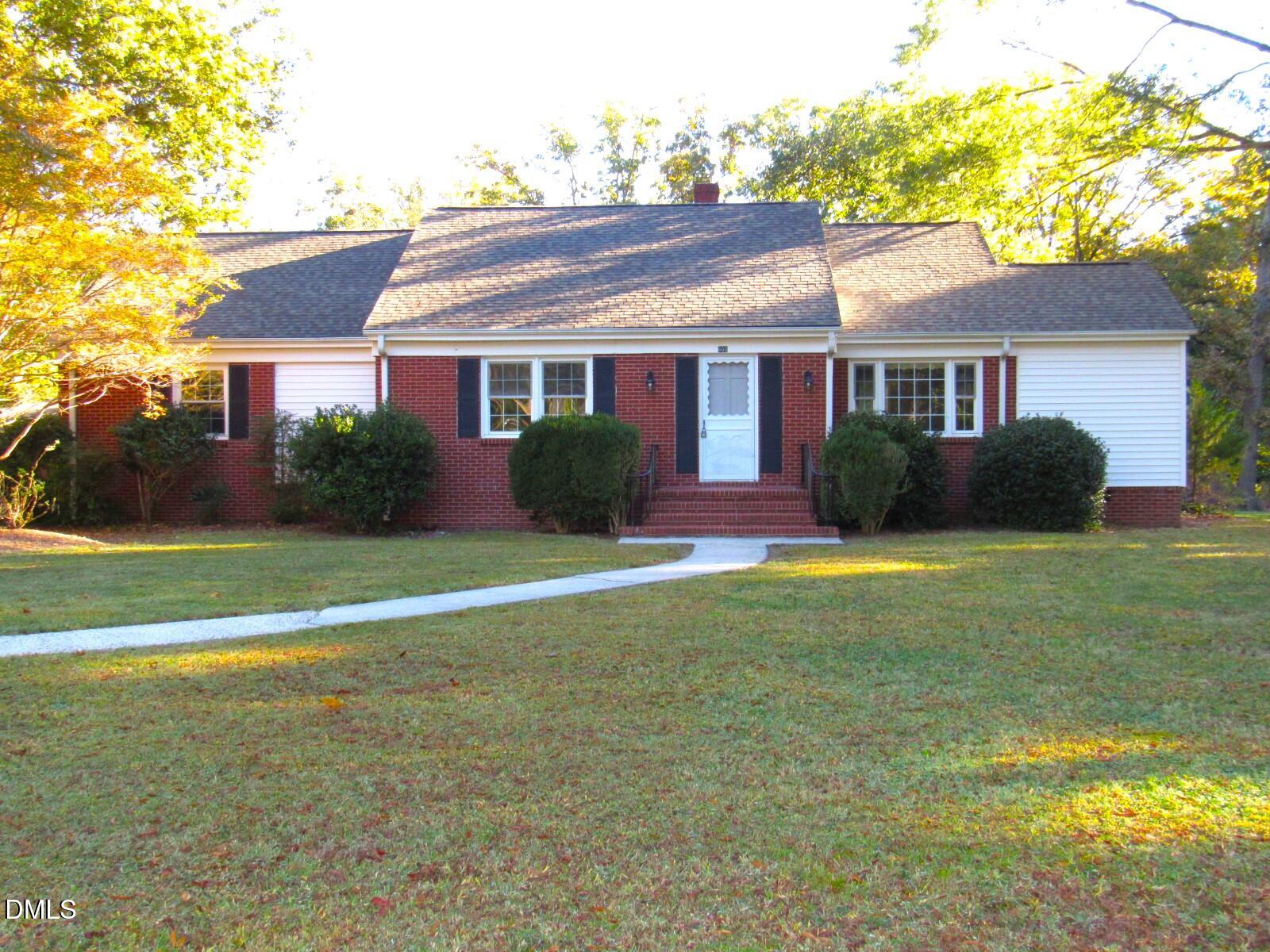 600 North 18th Street Butner, NC 27509 - Photo 1 of 56 a front view of a house with a yard and potted plants