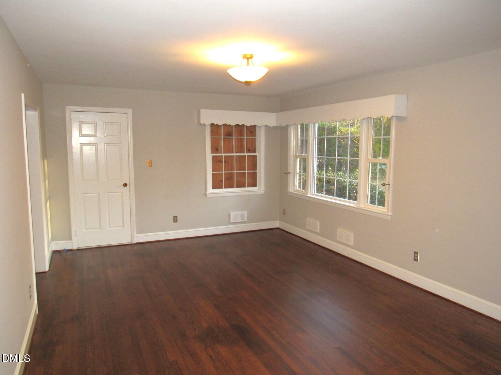 600 North 18th Street Butner, NC 27509 - Photo 3 of 56 an empty room with wooden floor and windows