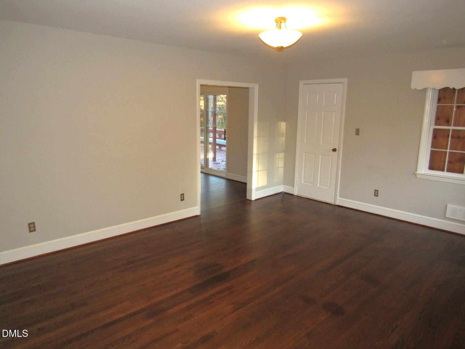 600 North 18th Street Butner, NC 27509 - Photo 5 of 56 an empty room with wooden floor and windows