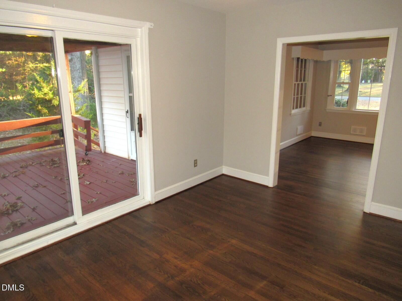 600 North 18th Street Butner, NC 27509 - Photo 8 of 56 an empty room with wooden floor and windows