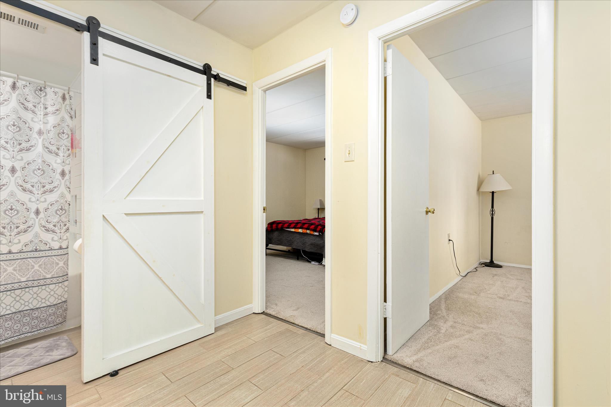 125 Clubhouse Drive Southwest, Unit 1 Leesburg, VA 20175 - Photo 11 of 17 a view of a hallway with a white walls and a bathroom with a shower