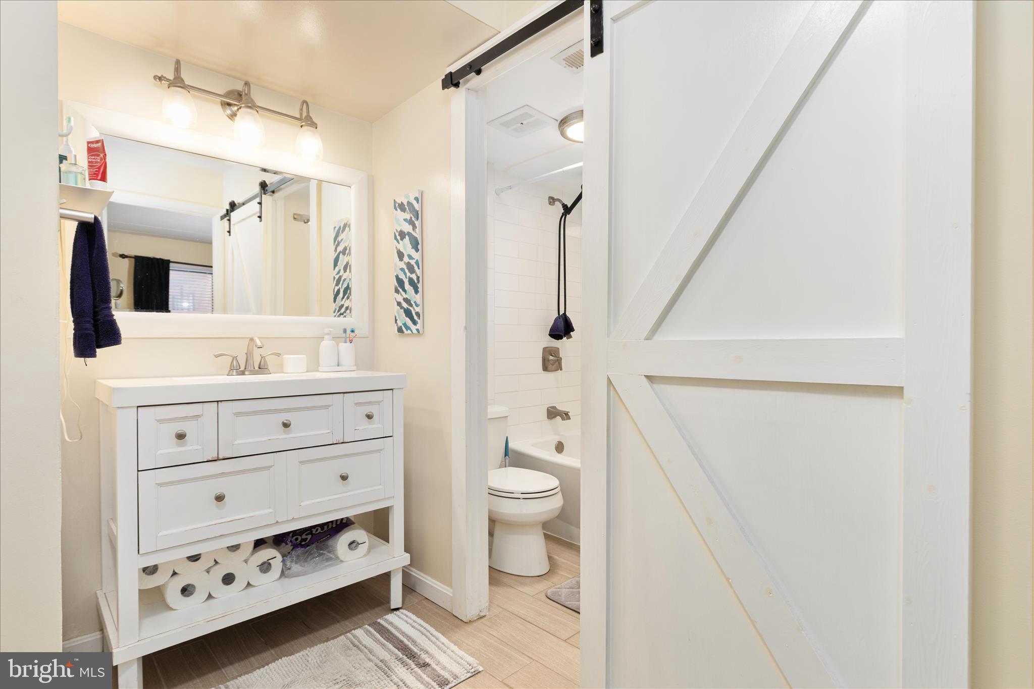 125 Clubhouse Drive Southwest, Unit 1 Leesburg, VA 20175 - Photo 12 of 17 a bathroom with a sink toilet and shower