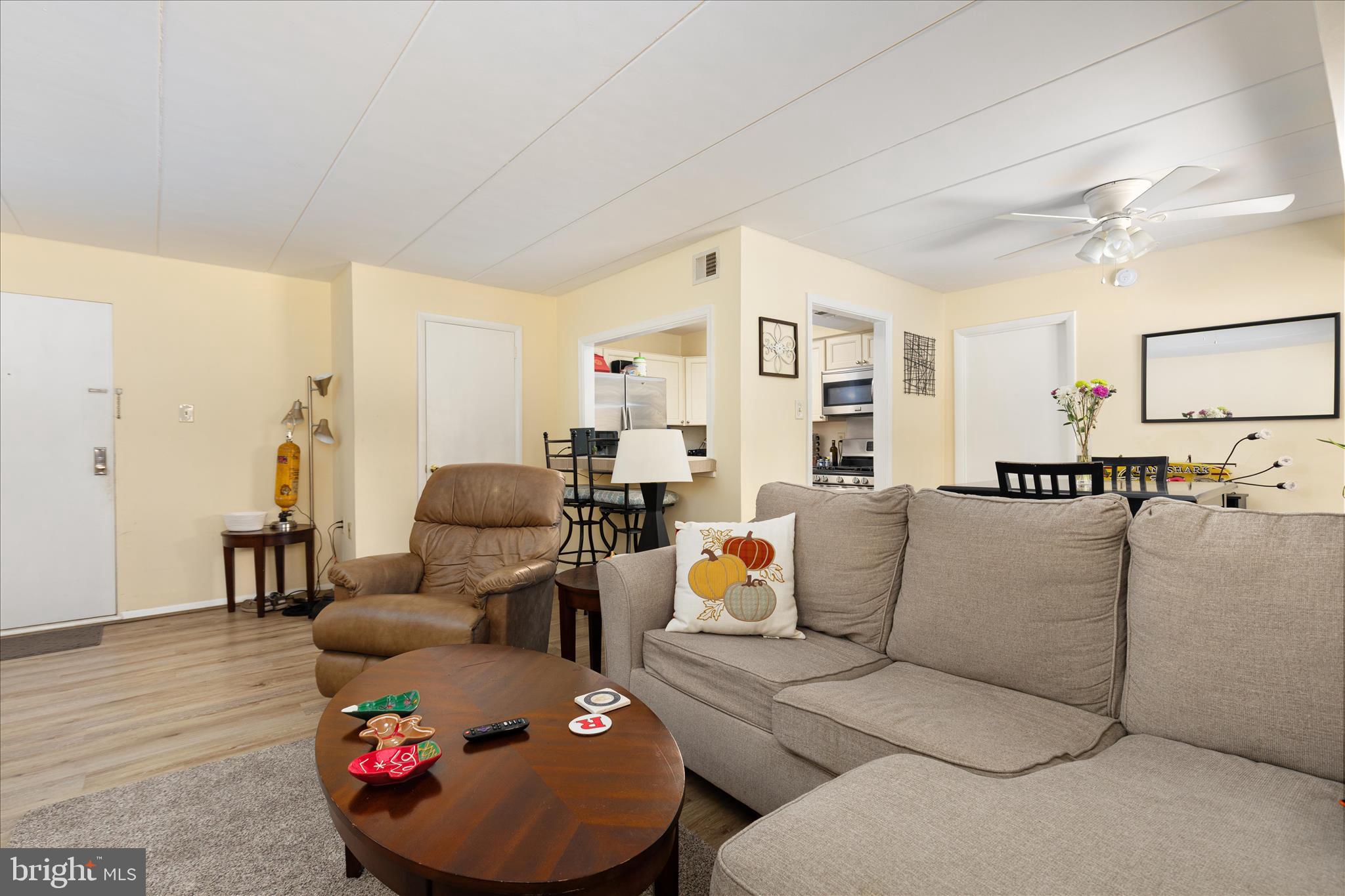 125 Clubhouse Drive Southwest, Unit 1 Leesburg, VA 20175 - Photo 3 of 17 a living room with furniture and a wooden floor
