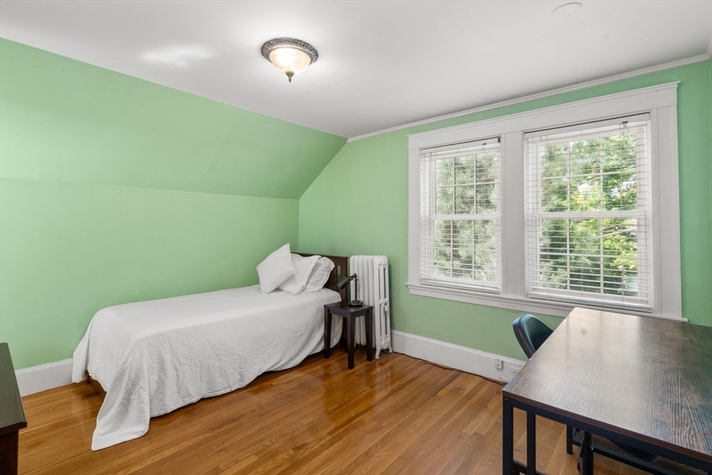 513 Chestnut Street Newton, MA 02468 - Photo 16 of 32 a bed sitting in a bedroom next to a window